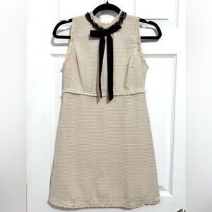 Elegant Cream Sleeveless Dress with Black Bow